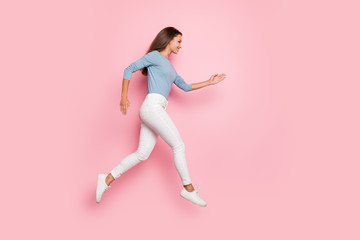 Fototapeta na wymiar Full length body size photo of cute pretty concentrated girl running into empty space in blue sweater for sales isolated pastel color background