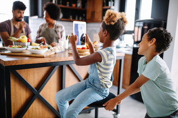 Happy family preparing healthy food in kitchen together
