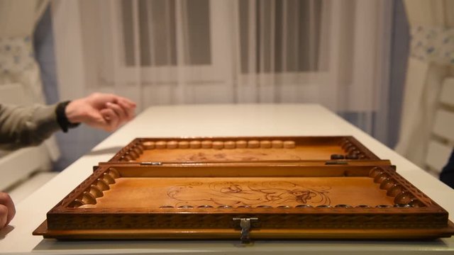 Beginning of a backgammon game with a player who throw dices on board