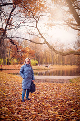 Fototapeta premium A woman walks in the autumn Park