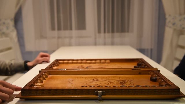 Beginning of a backgammon game with a player who throw dices on board