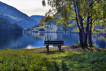 Fototapeta na wymiar beautiful view of a mountain lake in the autumn sunny day. Poschiavo, Switzerland
