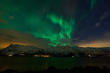 Amazing northern lights, Aurora borealis over the mountains in the North of Europe - Lofoten islands, Norway