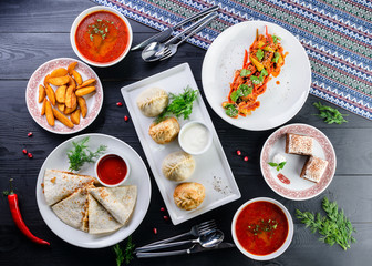 Assorted Uzbek food set, pilaf, samsa, lagman, manta and Korean carrots, set of uzbek food