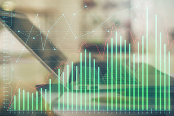 Forex graph hologram on table with computer background. Double exposure. Concept of financial markets.