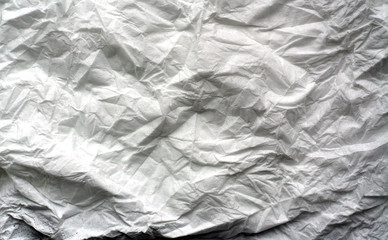 Crumpled sheet of white paper with blur effect.
