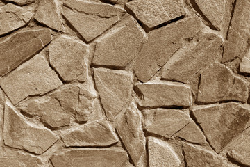Wall made of old stones in brown tone.
