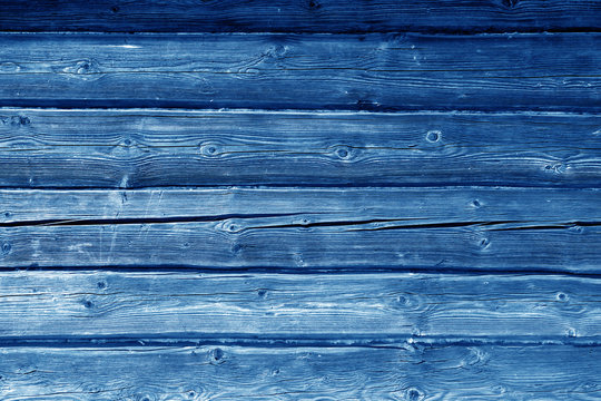 Old grungy wooden planks background in navy blue color.