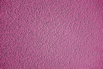 Grungy cement wall texture in pink color.