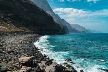 View of the black beach Playa de Guayedra in Las Palmas on Gran Canaria volcanic island, Spain,...