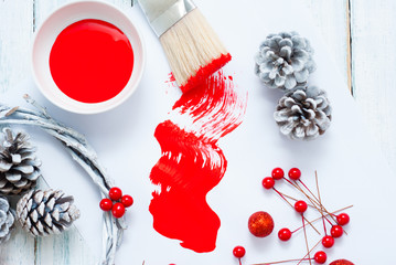 Christmas decoration making with red paint