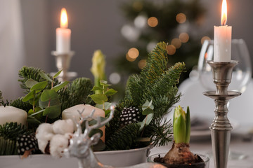 fragments of Christmas decor, cones, candles on the background of a decorated Christmas tree
