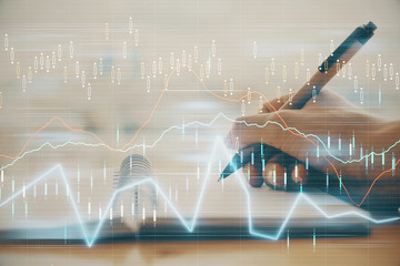 Forex graph on hand taking notes background. Concept of research. Multi exposure