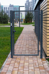 safety in modern residential buildings. fenced yard, closed gate with electronic lock.