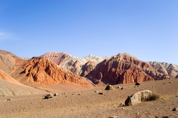 Martian landscape on earth. Mars on earth. Red rocks and a lifeless desert under the blue sky. Kyrgyzstan