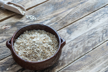 Bran oat in bowl in wooden background