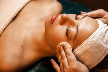 Close up upper view of a charming woman having a skin cleaning procedures in a spa salon.