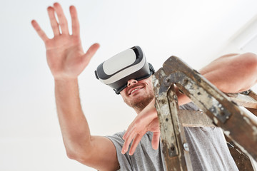 Handyman with VR glasses in virtual space planning