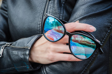 Black sunglasses in a female hand