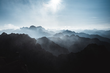 View on the mountains covered in fog from Mangart Pass that connect's Italian and Slovenian side,...
