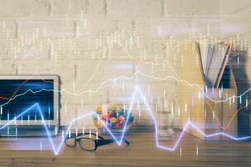 Double exposure of chart and financial info and work space with computer background. Concept of international online trading.
