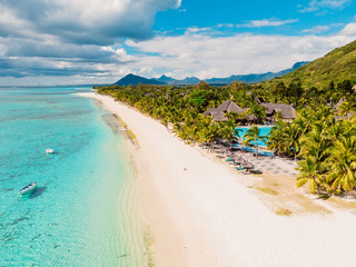 Luxury beach with mountain in Mauritius. Sandy beach with palms and ocean. Aerial view