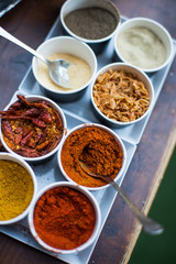 Various colored spices in recipients