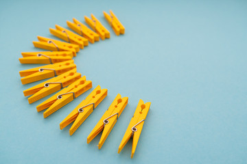 yellow plastic clothespins on blue background
