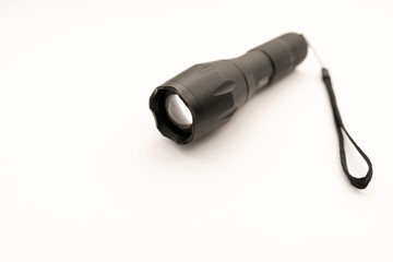 black battery-powered flashlight on white background