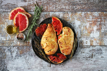 Baked chicken breasts with rosemary and grapefruit. Keto diet. Healthly food. Selective focus. Macro.