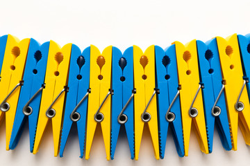 multi-colored plastic clothespins on white background