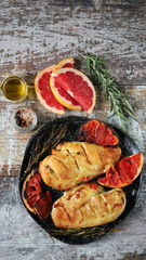 Baked chicken breasts with rosemary and grapefruit. Keto diet. Healthly food. Selective focus. Macro.