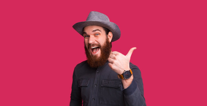 LIKE IT !!! Bearded man with hat, looking excitment at camera and showing thumb up