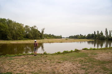 Boy looking at the river in the village of Apremont sur Allier in the region of Cher, designated a Les Plus Beaux Village or A Most Beautiful Village of France