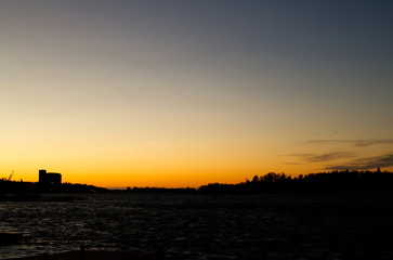 Fototapeta premium Sunset over the sea at Rauma Harbour, Finland on a clear evening
