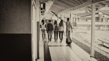 Back view of teenagers walking in the schoolyard