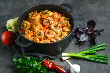 .Stuffed peppers with rice, meat and spices in a dark pan on a dark background..