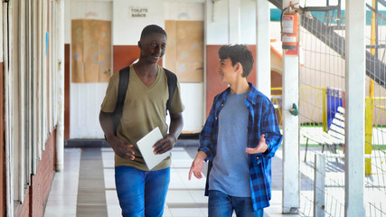 Multi ethnic group of students  at school talking waiting for school lesson