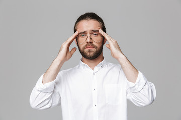 Man posing isolated over grey wall background wearing glasses.