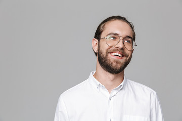 Bearded man posing isolated over grey wall background