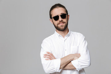 Bearded man posing isolated wearing sunglasses.