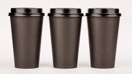 black paper cups on white background.