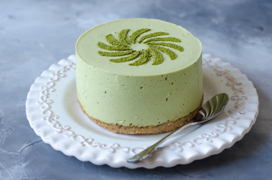 Cheesecake without baking with matcha tea on a white plate