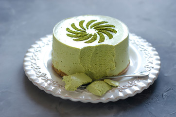 Cheesecake without baking with matcha tea on a white plate