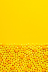 Yellow round pills  on yellow  background. Medicine and pharmacy concept.