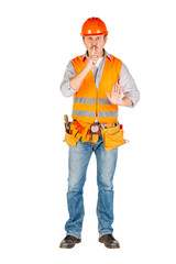 Portrait of a male builder in a helmet  looking at camera over white wall background. repair, construction, building, people and maintenance concept.