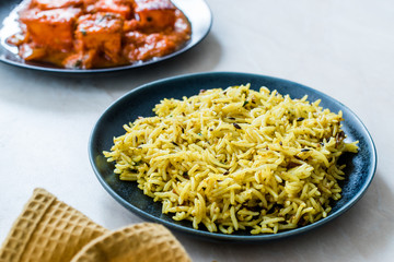 Indian Food Jeera Zira Rice Basmati Pilaf or Pilav with Paneer Butter Tikka Masala / Cheese Cottage Curry.