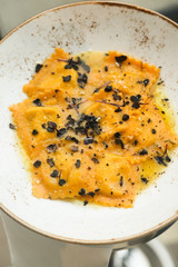 Truffle ravioli on a white plate