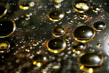 Text quote about rainy days in golden oil bubbles macro background with bokeh fifty megapixels