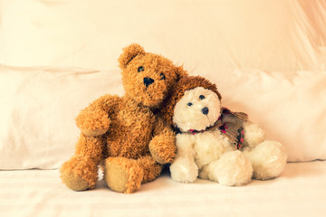 Relaxing time, two teddy bear friend sitting in the bed, vintage warm light filter, happy lovely teddy bear couple, together forever